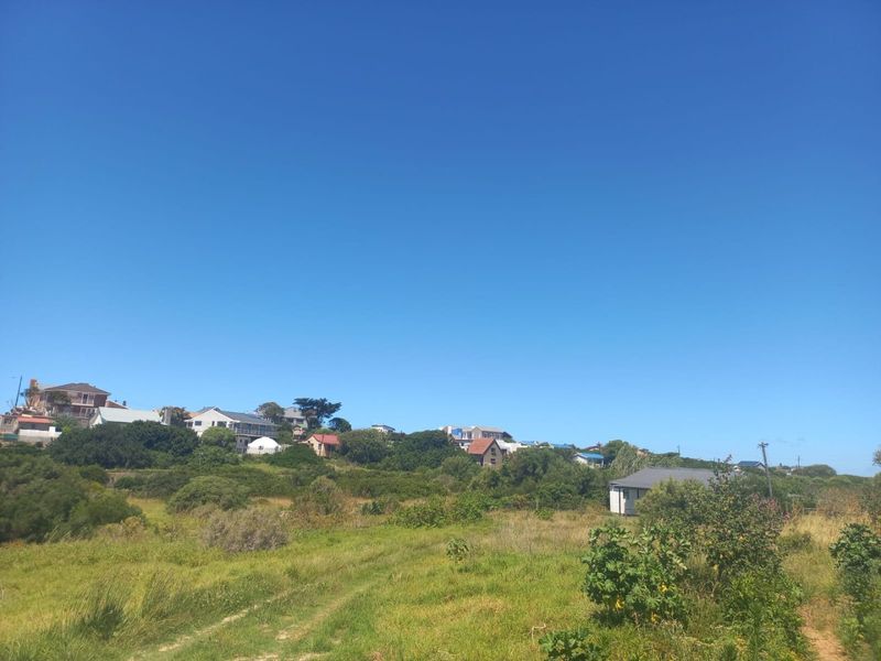 A scenic view of the surrounding landscape and neighboring properties, showcasing the natural terrain and open space of the farm area.