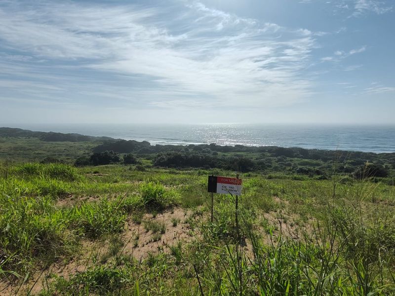A scenic view of the coastline and ocean from the vacant residential land plot.