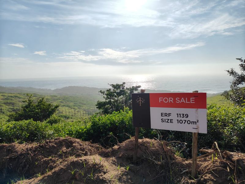 A scenic view of the coastline and ocean from the vacant residential erf, showcasing the natural landscape and elevated position.