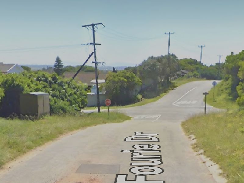 A street view of Fourie Drive showing the intersection, asphalt road surface, and surrounding utility infrastructure.