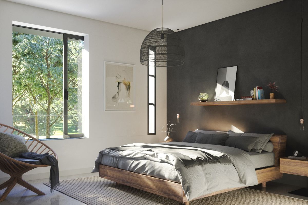 A modern, well-lit bedroom featuring a dark accent wall, large windows with natural views, and a floating wooden shelf.
