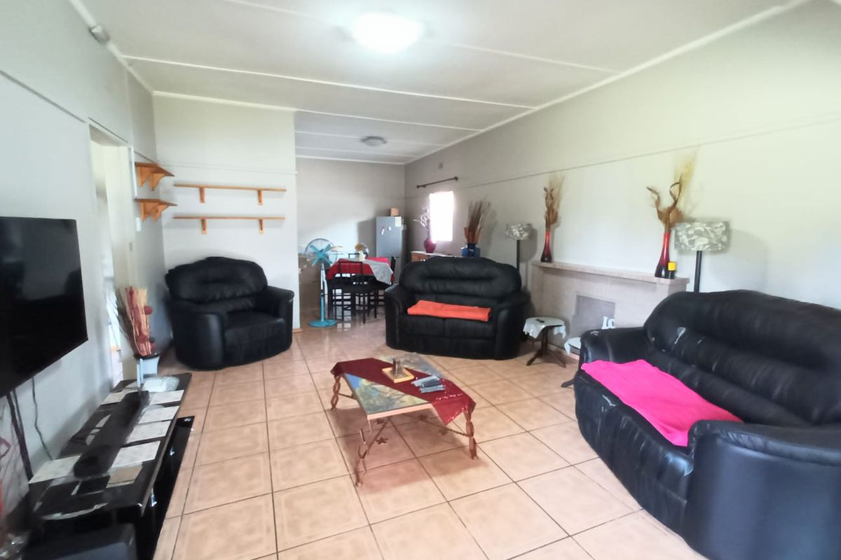 Spacious living area featuring tiled flooring and a built-in fireplace mantel, offering a functional layout for comfortable family living.