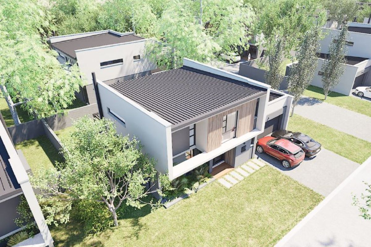 An aerial view of a modern two-story residential property featuring a flat roof, contemporary facade, and a paved driveway.