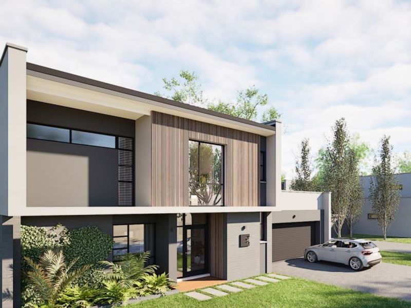 Modern two-story residential facade featuring timber cladding, large glass windows, a paved driveway, and an integrated garage.
