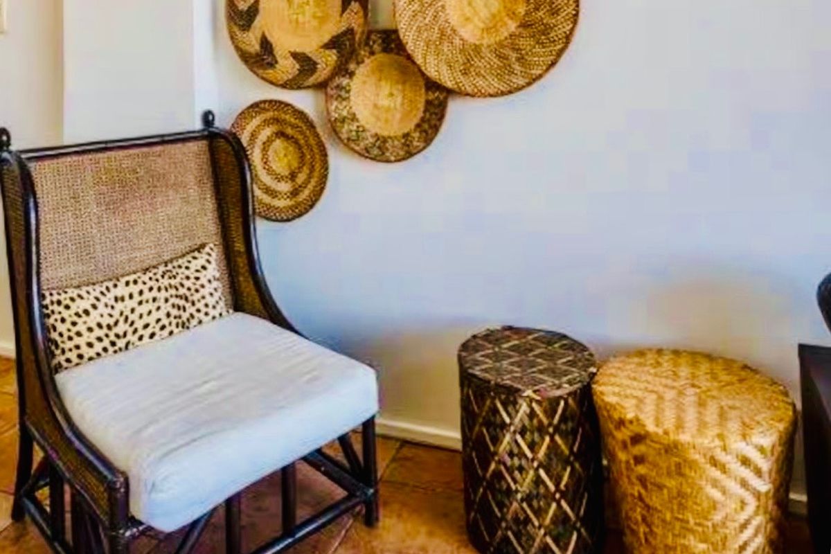 A corner of a living area featuring tiled flooring and neutral wall finishes.