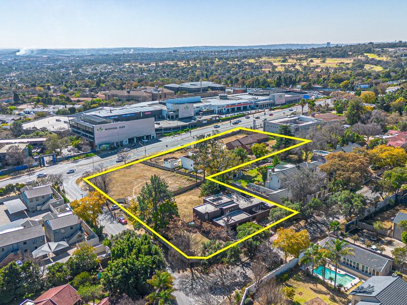 Aerial view of a vacant residential land parcel with existing structures, highlighting the property boundaries and surrounding urban landscape.