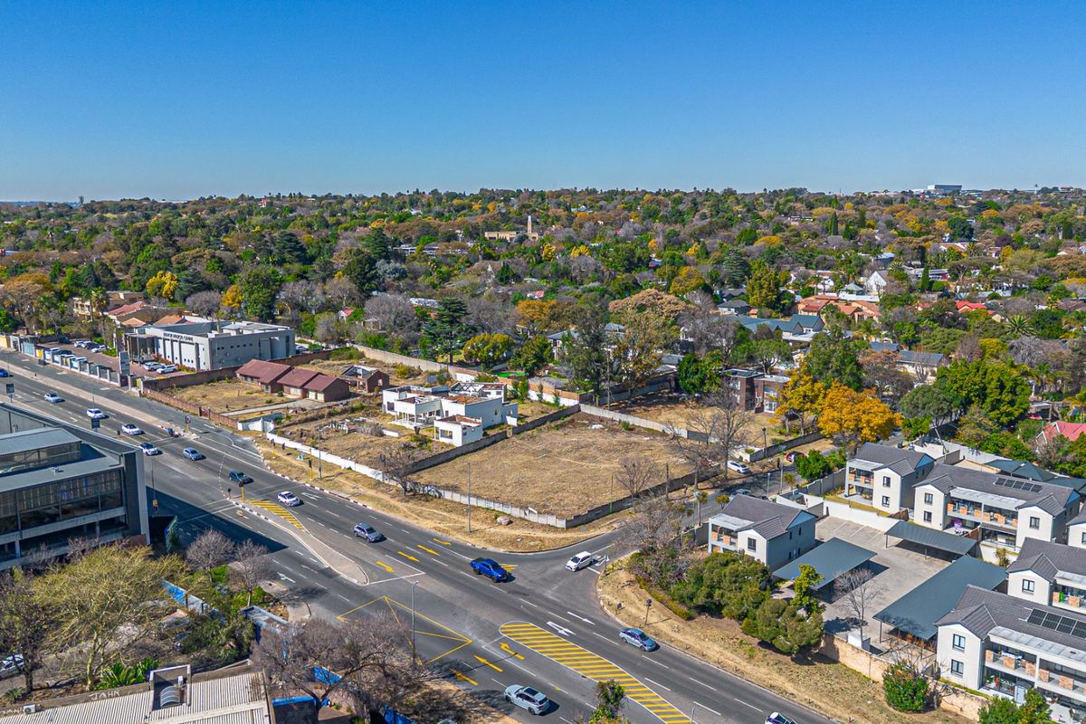 Aerial view of a vacant residential plot situated in a developed urban area with established road access and surrounding infrastructure.