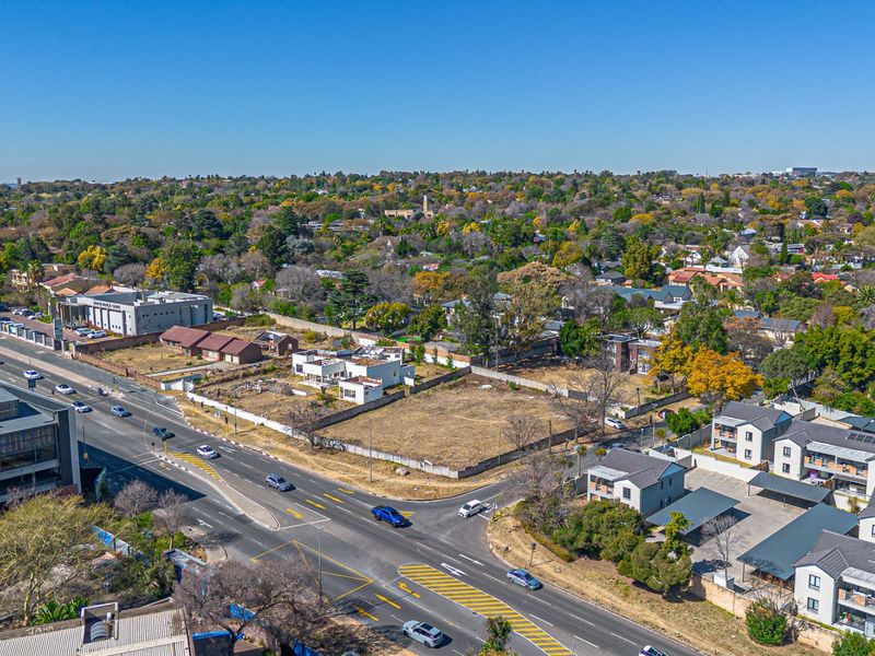 Aerial view of a vacant residential plot situated in a developed urban area with established road access and surrounding infrastructure.