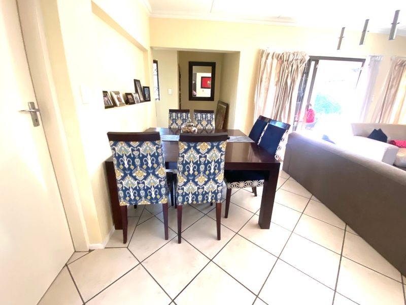 Open plan dining area featuring ceramic tile flooring and direct access to the patio through sliding glass doors.