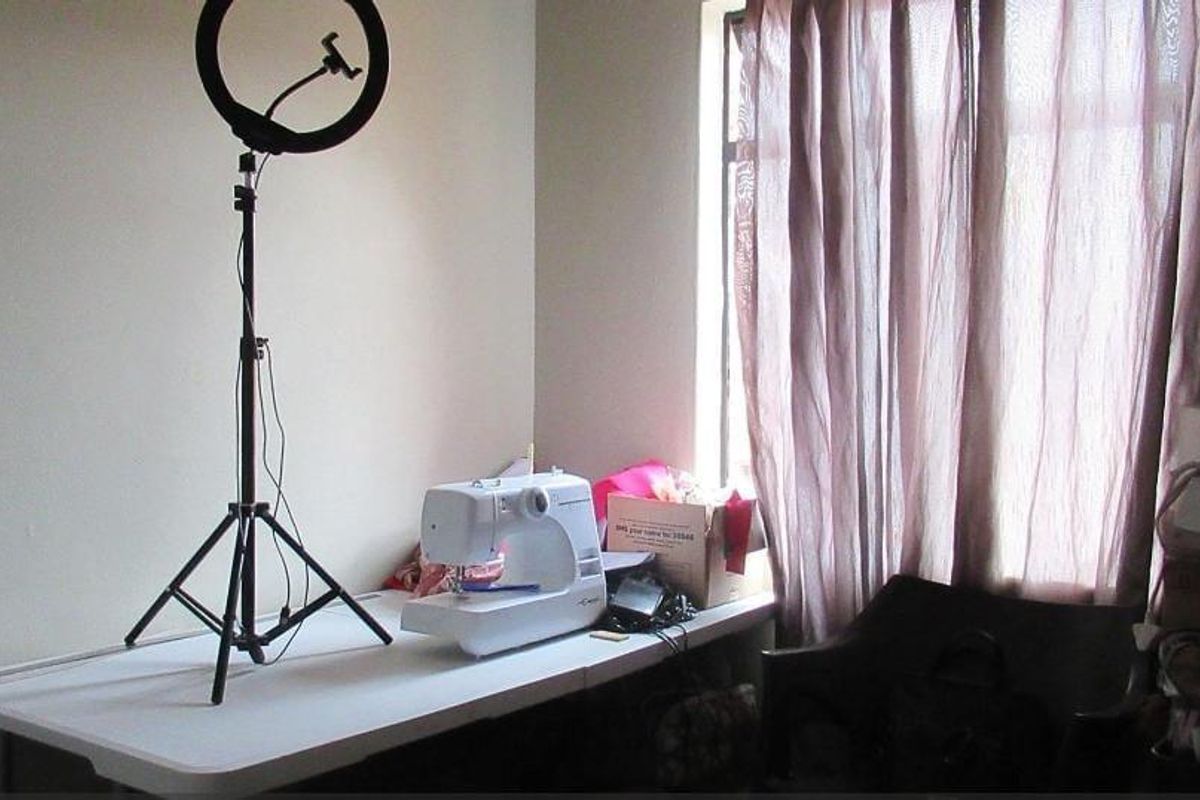 A functional bedroom space featuring a window with curtains, suitable for use as a private sleeping area or home office.