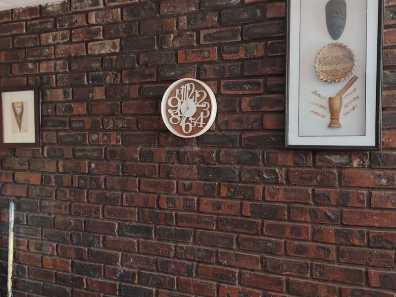 A living area featuring a prominent exposed brick feature wall, providing a rustic texture to the interior space.