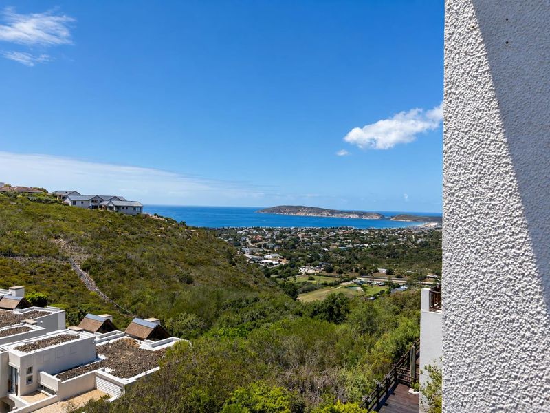 A scenic elevated view overlooking the coastal landscape, surrounding residential area, and the ocean.