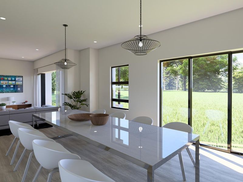Spacious open-plan living and dining area featuring modern pendant lighting, large sliding glass doors, and neutral finishes with views of the garden.