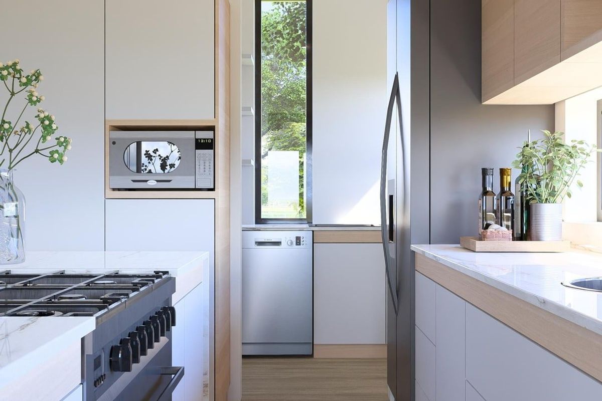 Modern galley-style kitchen featuring sleek cabinetry, stone countertops, integrated appliances, and a gas cooktop, finished with high-quality contemporary fixtures.