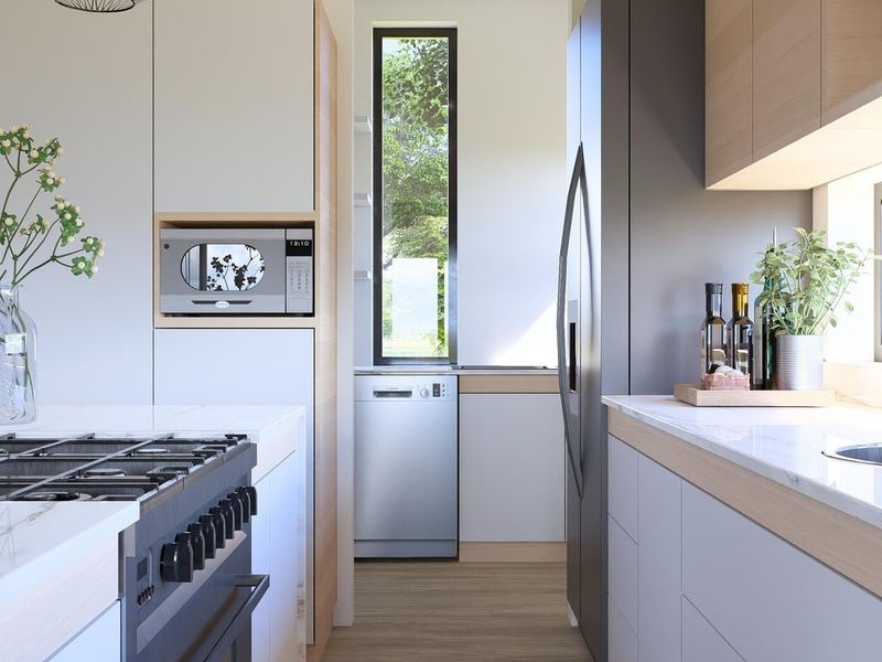 Modern galley-style kitchen featuring sleek cabinetry, stone countertops, integrated appliances, and a gas cooktop, finished with high-quality contemporary fixtures.