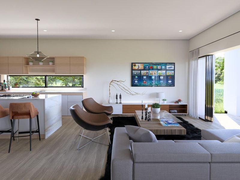 Modern open-plan living area featuring a sleek kitchen with island, seamless indoor-outdoor flow through sliding doors, and a contemporary outdoor fireplace.