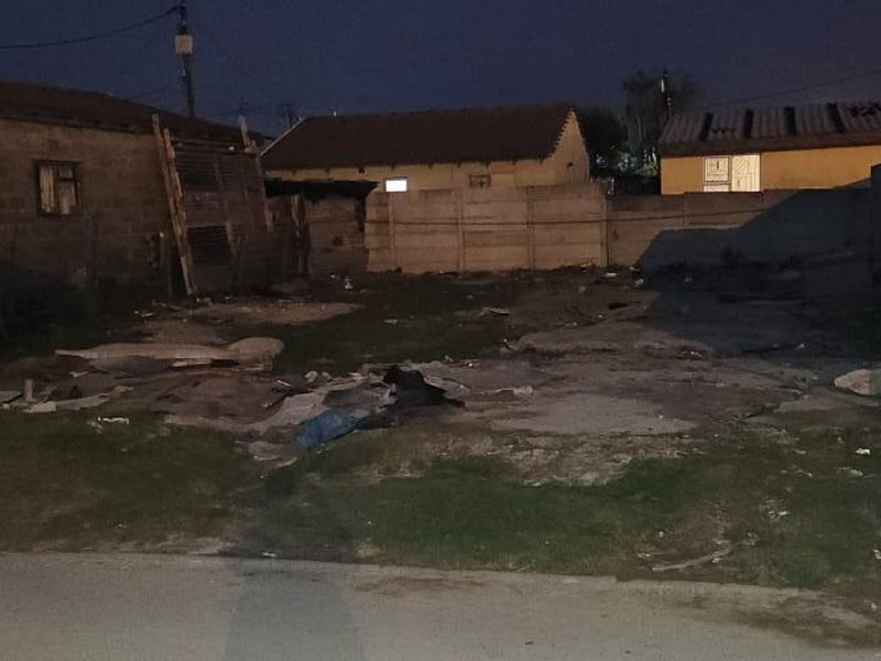 Vacant residential land featuring a concrete slab foundation and enclosed by precast concrete boundary walls, requiring site clearance and development.