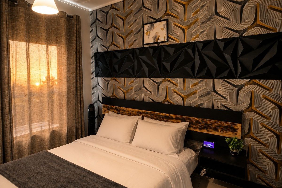A well-appointed bedroom featuring a striking geometric feature wall, integrated headboard, and warm pendant lighting, creating a cozy and modern atmosphere.