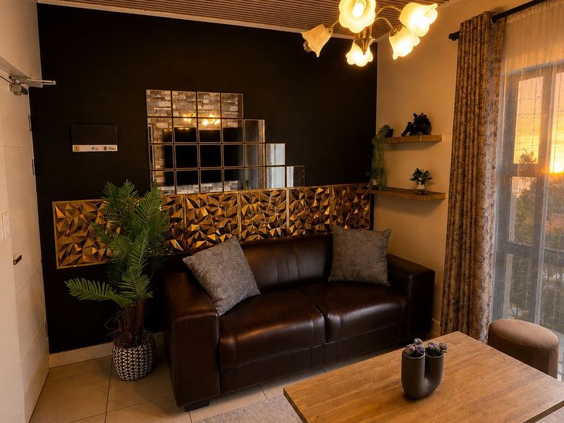 A cozy living room featuring a unique slatted timber ceiling, tiled flooring, and a sliding glass door providing natural light.