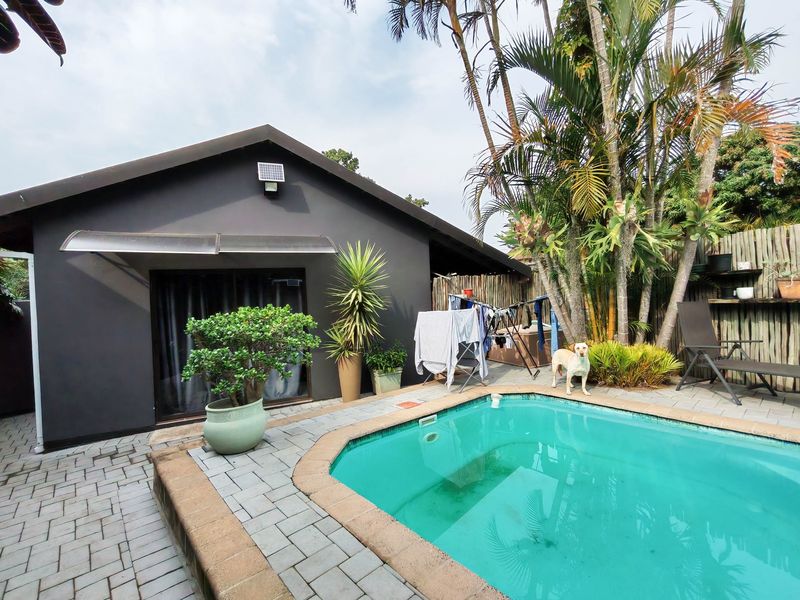 Outdoor pool area featuring a paved patio, swimming pool with coping, and direct access to the home via a sliding glass door.