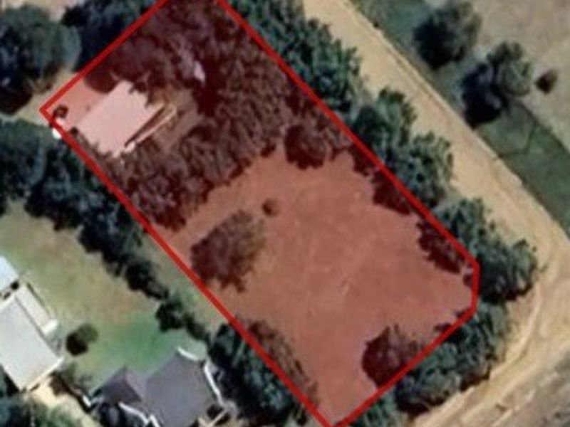 An aerial view showing the property boundary and land plot layout.