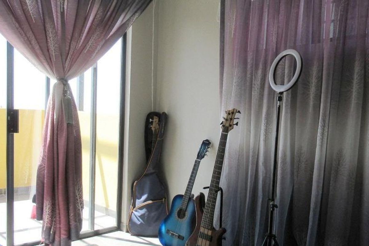Bedroom featuring a sliding glass door providing access to an outdoor area, finished with neutral walls and curtain fixtures.