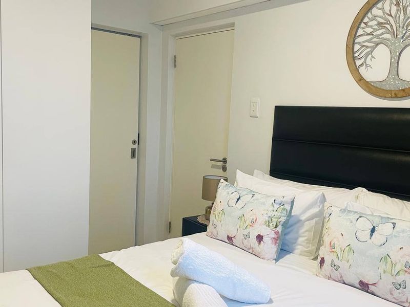 A well-maintained bedroom featuring built-in wardrobes and neutral finishes, providing a clean and functional living space.