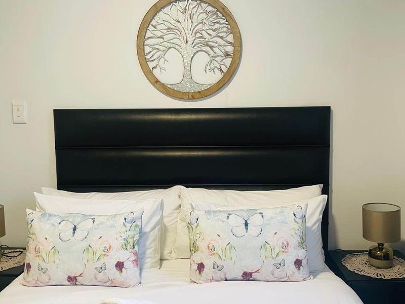 A well-maintained bedroom featuring a neutral color palette and a clean, modern aesthetic.