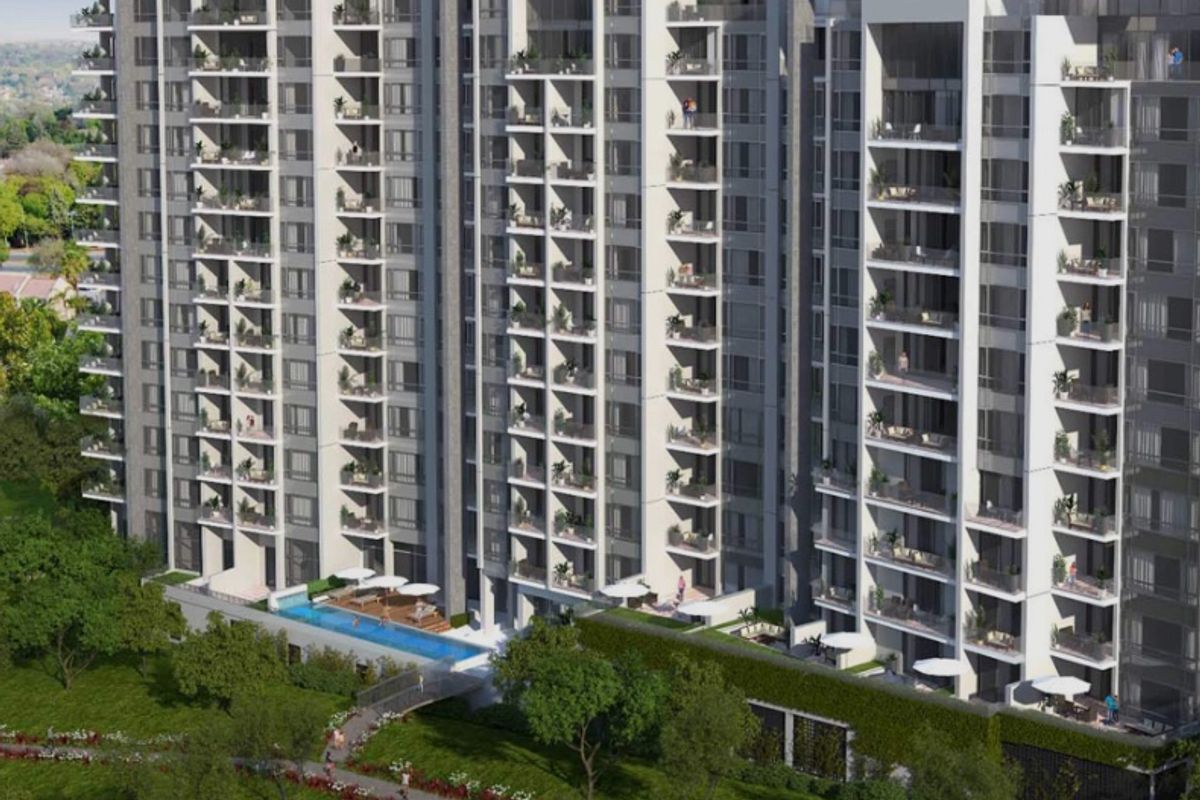 Aerial view of a modern high-rise apartment complex featuring extensive balconies, a swimming pool, and landscaped grounds.