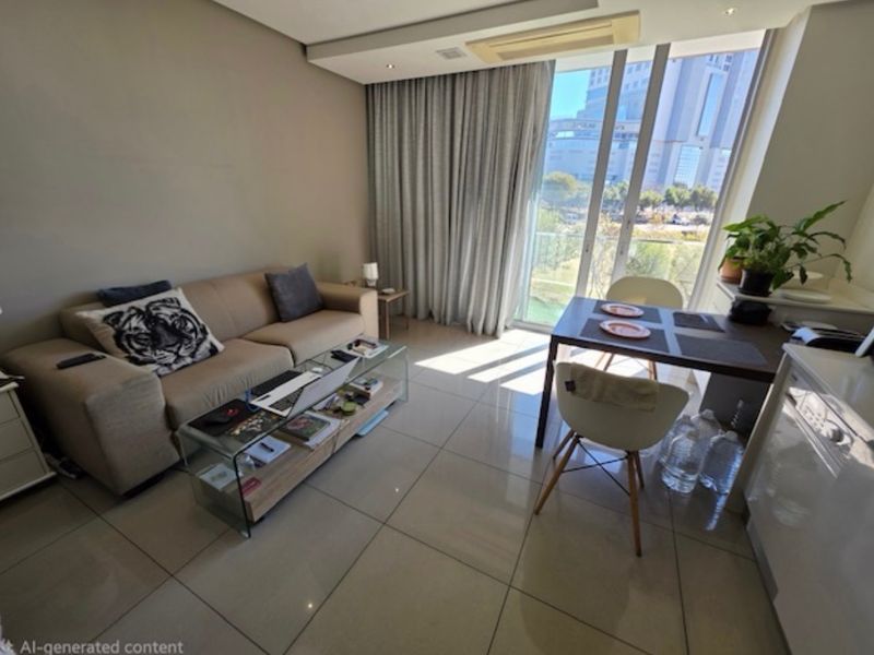Modern open-plan living and dining area featuring large floor-to-ceiling glass doors, neutral porcelain tiling, and integrated ceiling air conditioning.