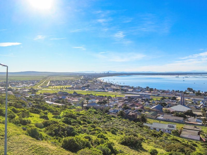 Elevated panoramic view overlooking the coastal town, surrounding landscape, and the bay area.