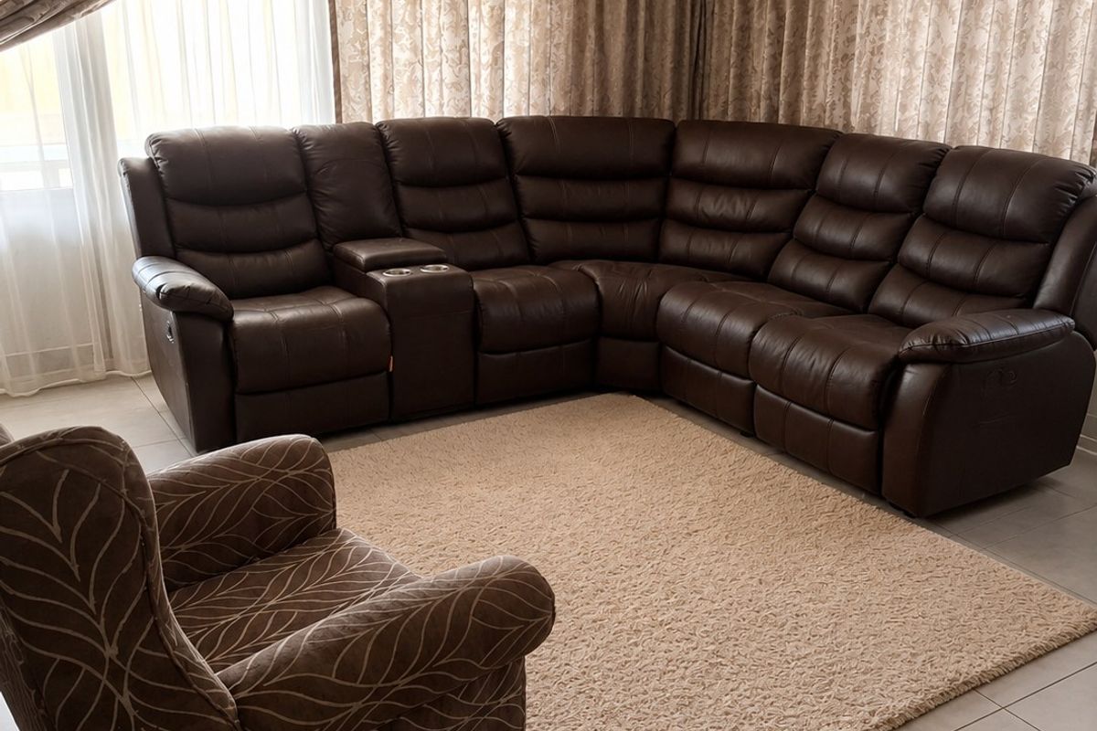 A comfortable living room featuring neutral tiled flooring and a recessed ceiling design, creating a bright and inviting space.