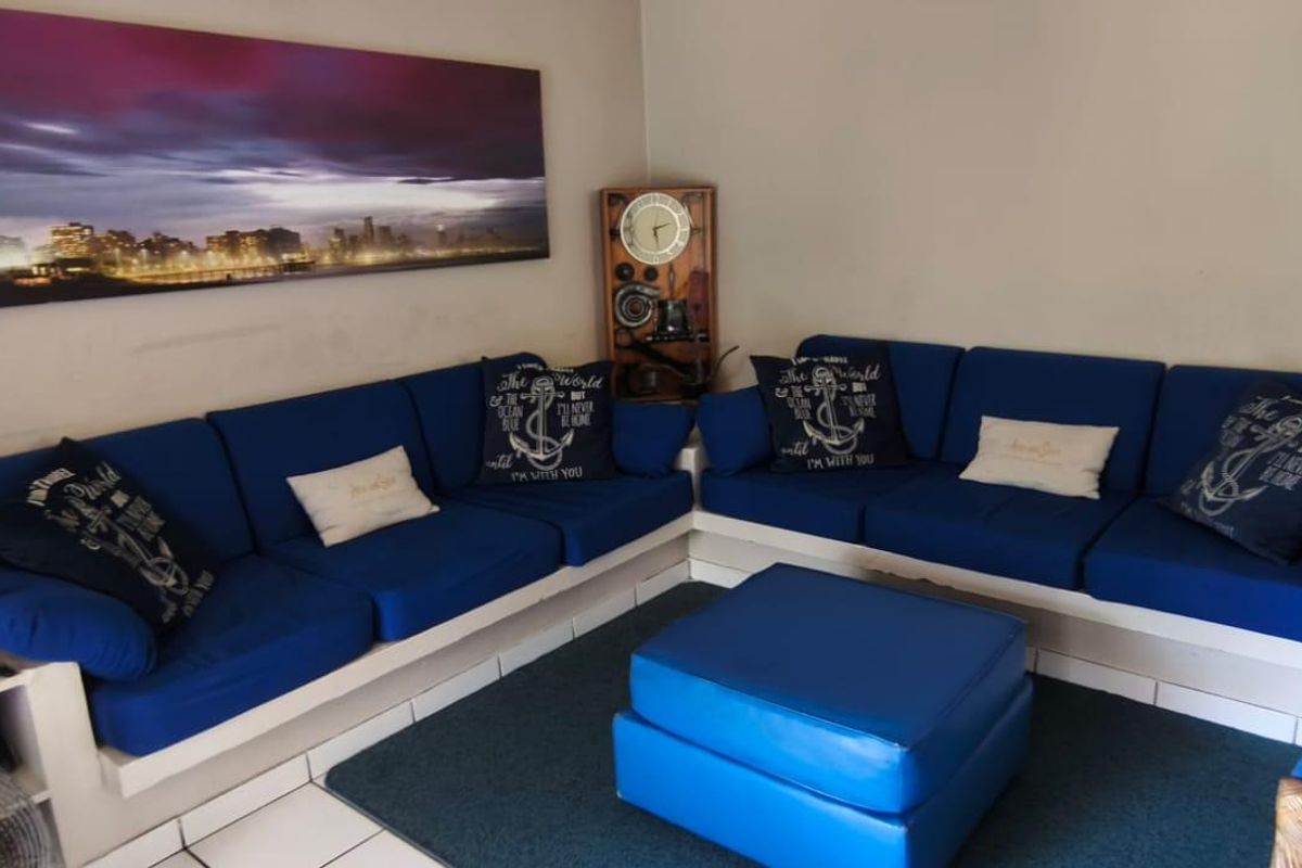 A living room area featuring tiled flooring and neutral wall finishes, providing a functional space for relaxation.