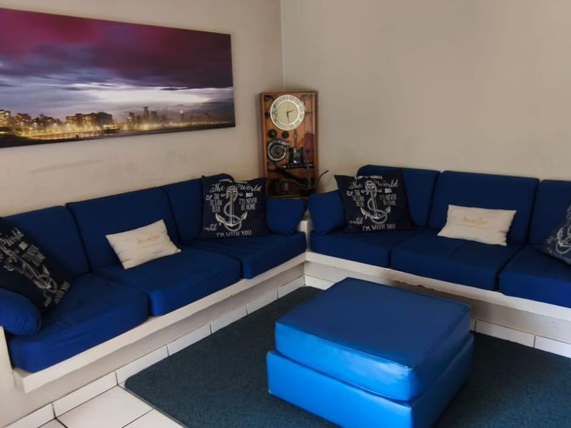 A living room area featuring tiled flooring and neutral wall finishes, providing a functional space for relaxation.