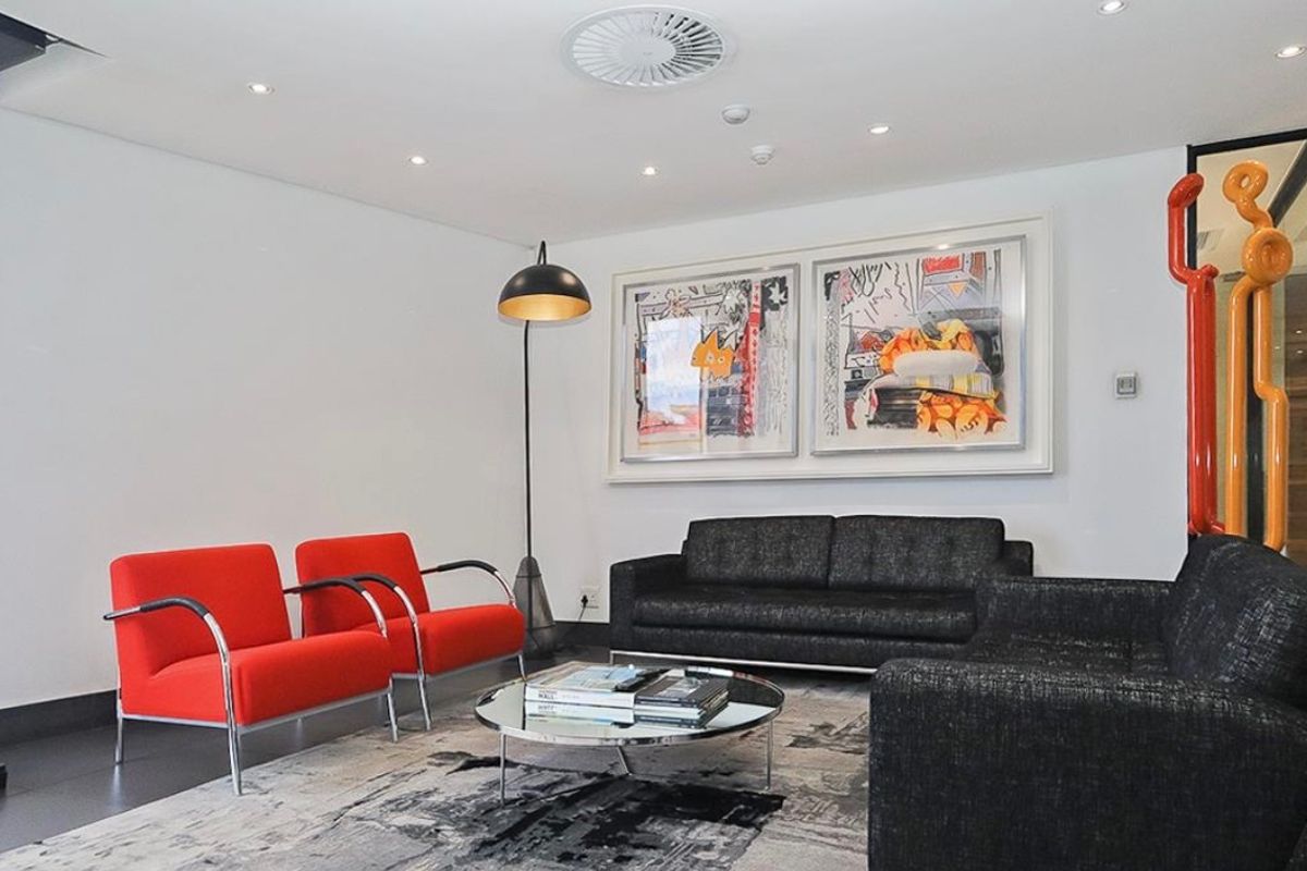 A modern, well-maintained commercial reception or lounge area featuring recessed lighting and integrated ceiling ventilation systems.