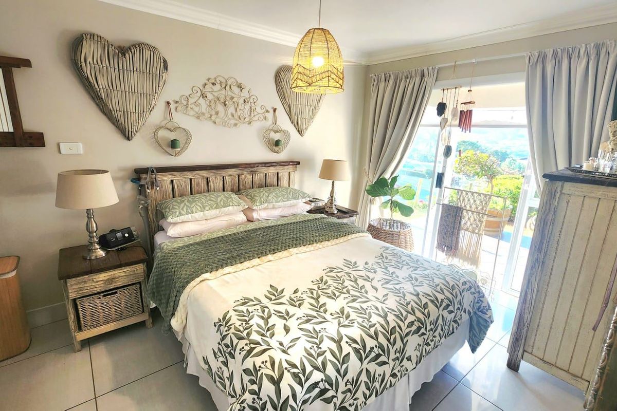 A well-maintained bedroom featuring tiled flooring and a sliding glass door providing access to an outdoor area.
