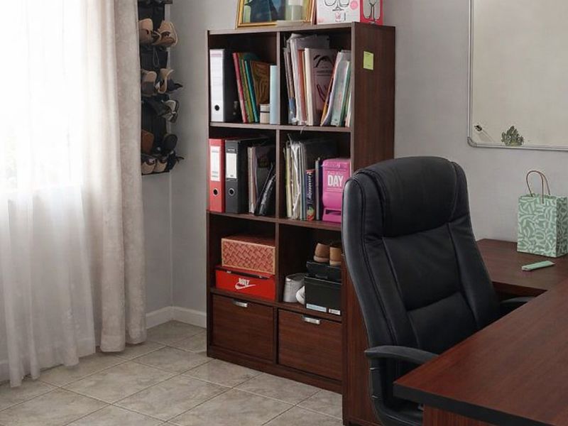 A functional home office space featuring tiled flooring and neutral wall finishes, suitable for a dedicated workspace or study area.