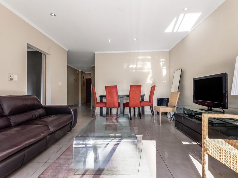 Open plan living and dining area featuring tiled flooring and recessed ceiling lighting, providing a functional and versatile space for daily living.