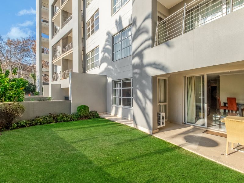 Ground floor apartment featuring a private garden and a covered patio area with sliding door access to the interior living space.