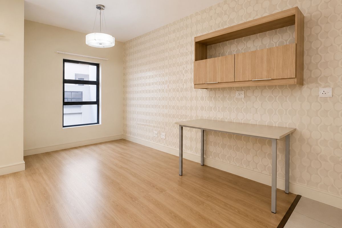 A bright, modern bedroom or office space featuring wood-look laminate flooring, patterned wallpaper, and built-in wall-mounted cabinetry.