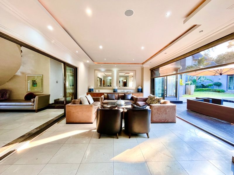 Spacious open-plan living area featuring large sliding glass doors that provide seamless indoor-outdoor flow to the patio and garden.