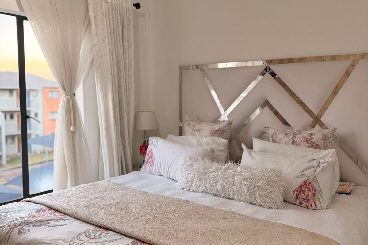 A well-maintained bedroom featuring a large sliding glass door that provides natural light and access to an outdoor view.