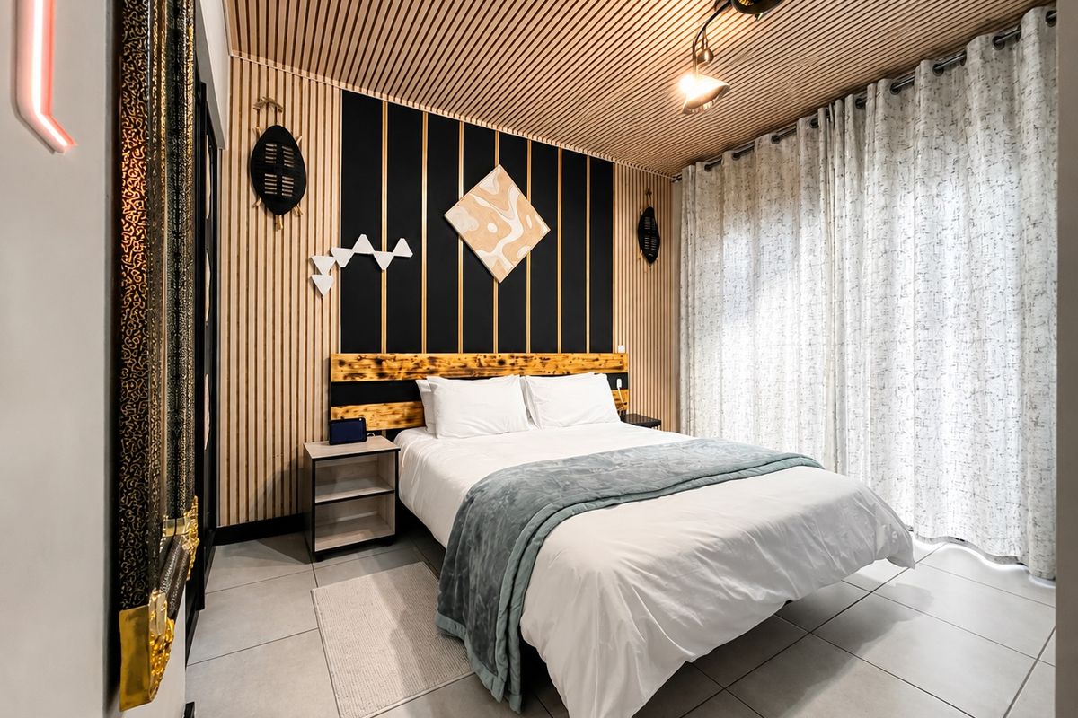 Modern bedroom featuring unique slatted timber ceiling and wall paneling, tiled flooring, and a custom built-in headboard design.