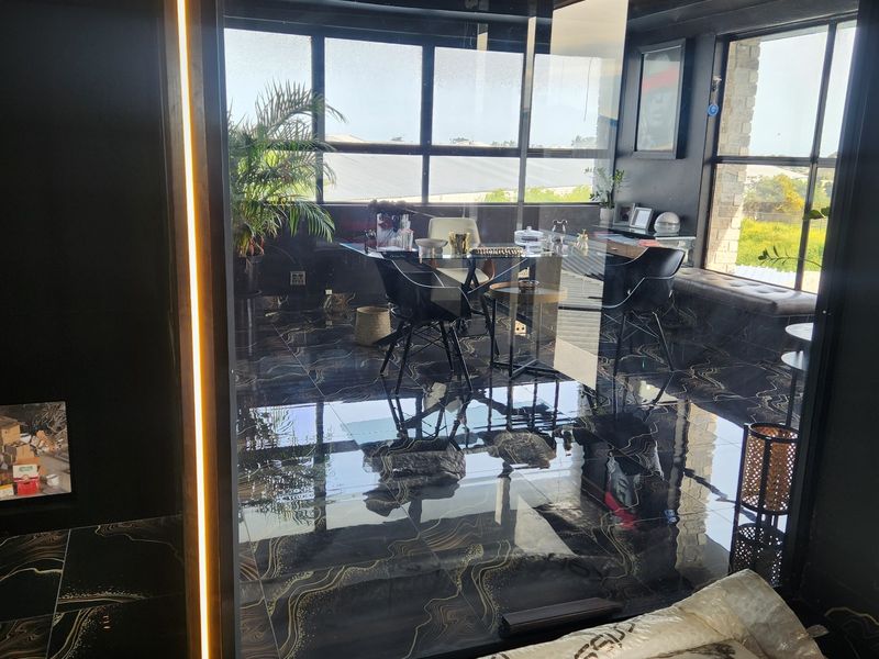 Modern office space featuring high-end marble-look flooring, glass partitioning, and integrated LED lighting, offering a sleek and professional commercial environment.