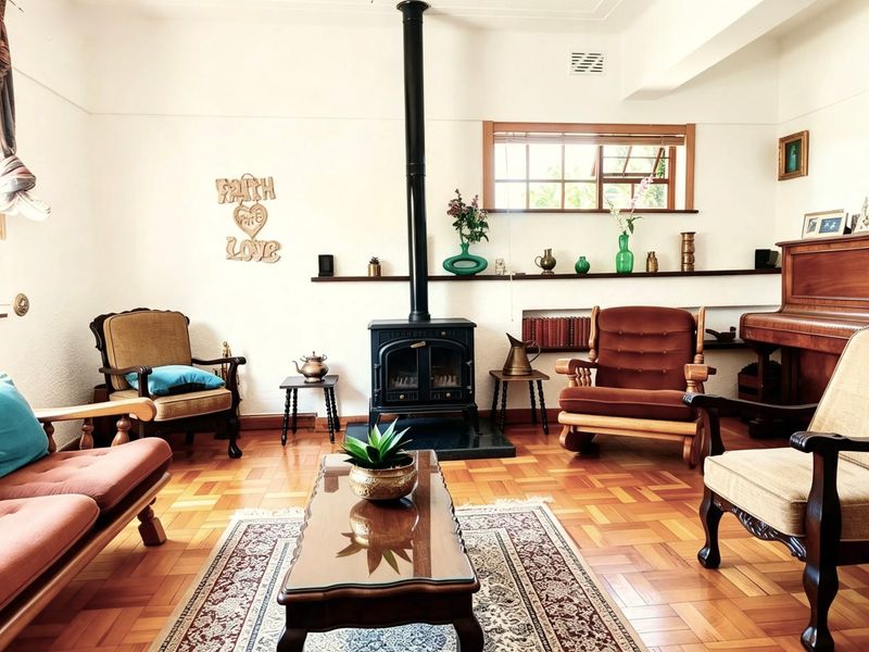A cozy living room featuring classic parquet flooring and a prominent freestanding wood-burning fireplace as a central focal point.