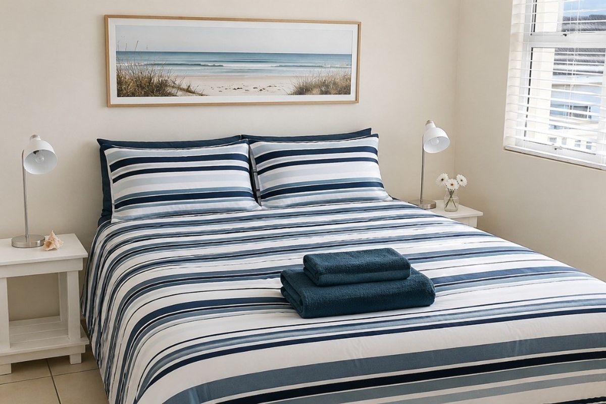 A well-maintained bedroom featuring tiled flooring, built-in cupboard storage, and venetian blinds allowing natural light.