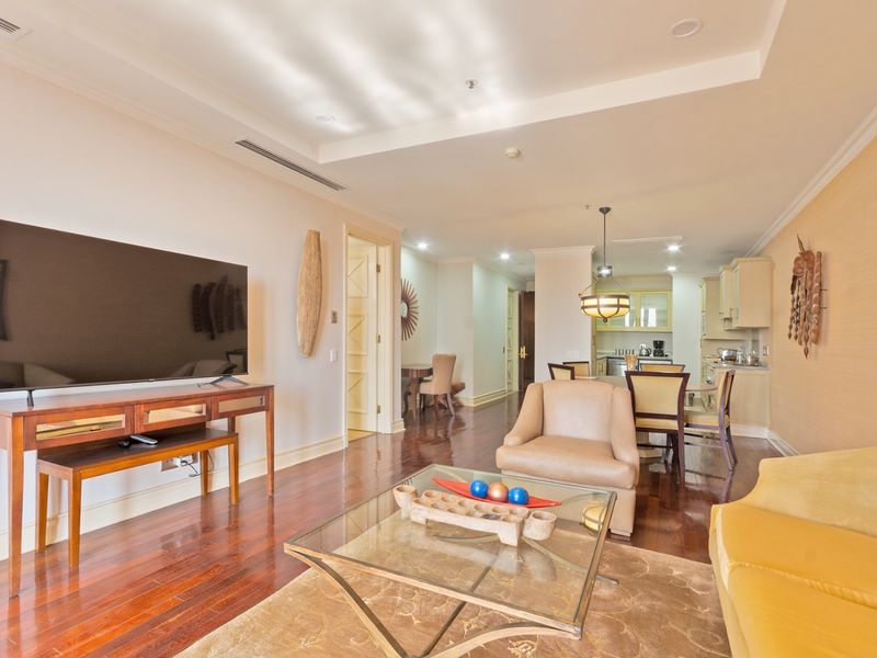 Spacious open-plan living and dining area featuring polished hardwood floors, recessed lighting, and a seamless transition to a functional kitchen space.