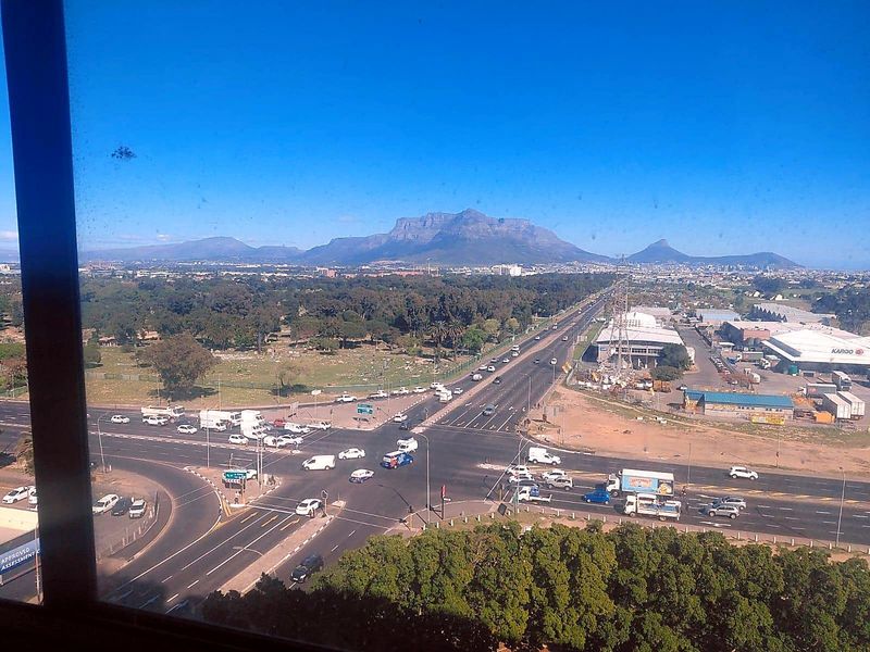 Elevated panoramic view overlooking a major intersection, surrounding landscape, and distant mountain range.