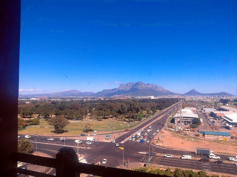 Elevated panoramic view overlooking the surrounding landscape, major road intersection, and distant mountain range.