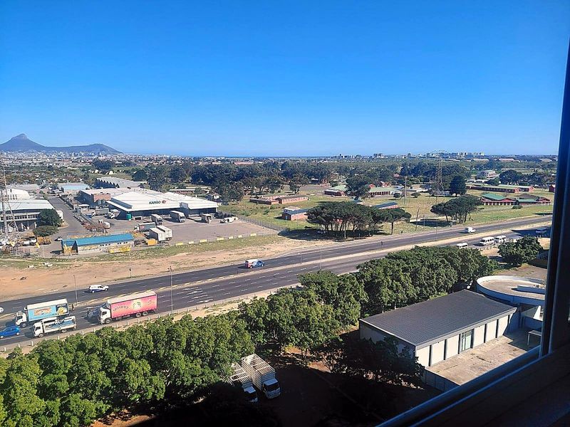 Elevated panoramic view overlooking the surrounding landscape, highway, and industrial area from the apartment.